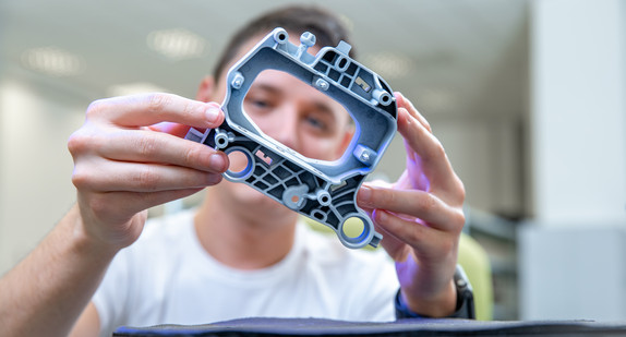 Quality engineer examines a sample scanned with a laser on a 3d scan in a research laboratory