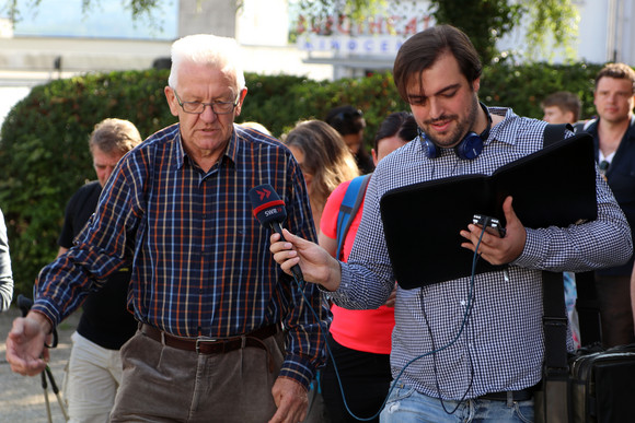 Sommertour Kretschmann wandert mit Bürgerinnen und Bürgern Hechinger Marktplatz: Ministerpräsident Winfried Kretschmann (l.) spricht mit einem Reporter