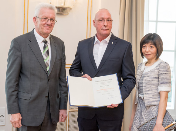 Auszeichnung Verdienstkreuz am Bande für Uwe Hück v.l.n.r.: Ministerpräsident Winfried Kretschmann, Uwe Hück und dessen Ehefrau