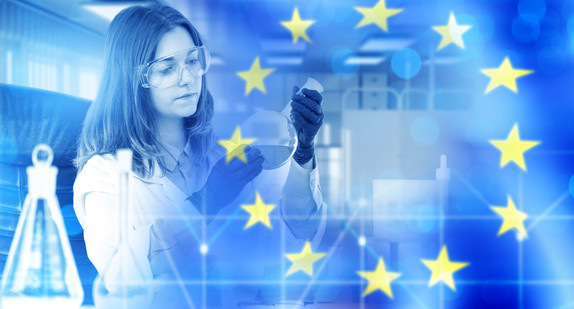 Female scientist in laboratory working with flasks, European Union flag overlay, research, biotechnology, pharmaceuticals, healthcare, science, innovation.