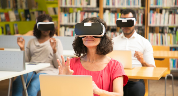 Diverse group of students using VR simulators during class