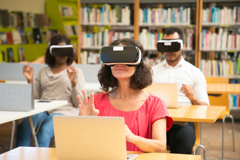 Diverse group of students using VR simulators during class
